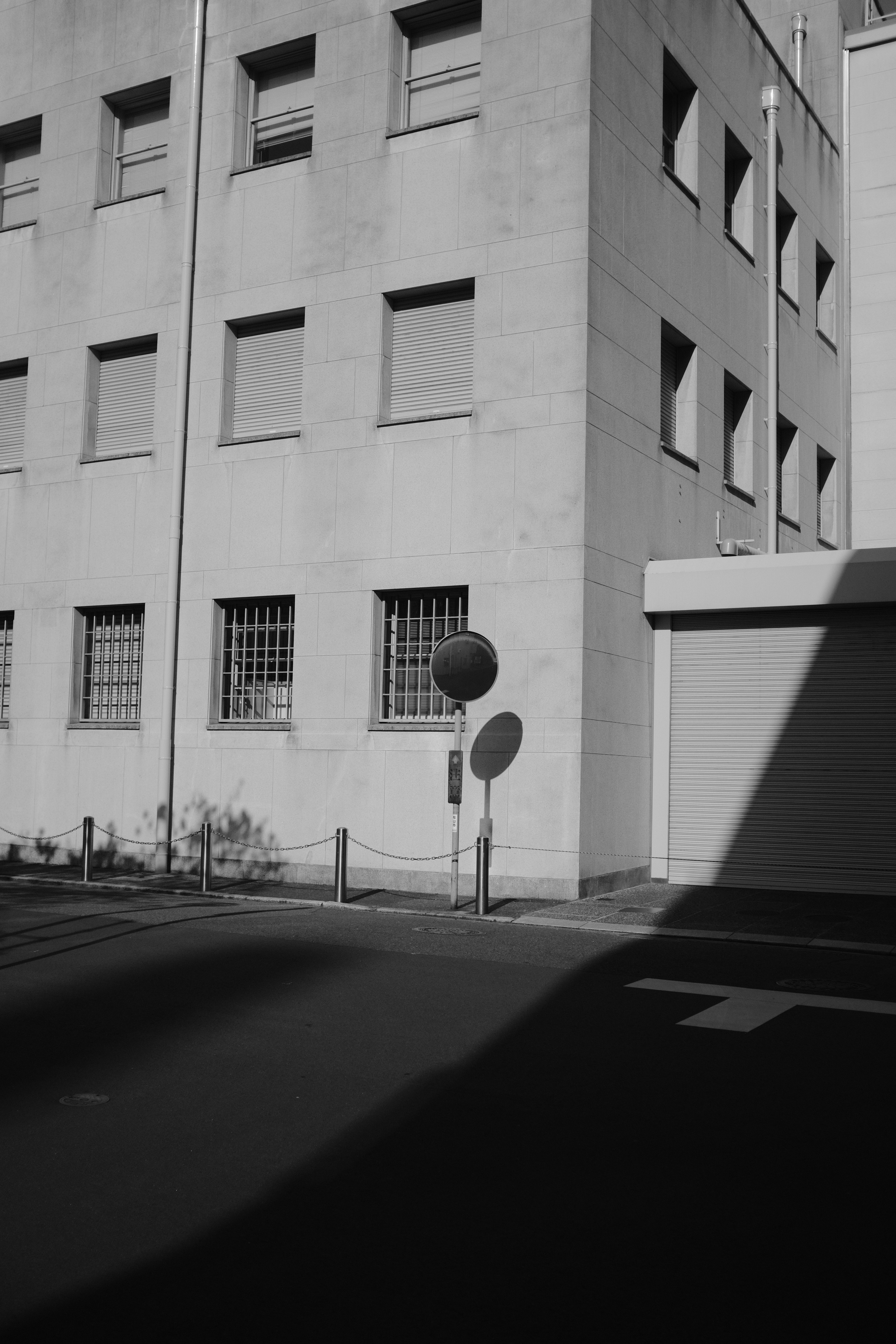 grayscale photo of street light near building